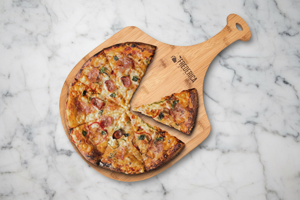 Wooden pizza peel with a pizza on a marble surface